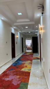 a hallway with a colorful rug on the floor at Roseau Hotel And Spa in Gonder