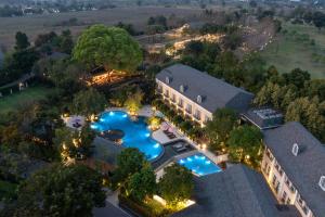 an overhead view of a house with a swimming pool at Rancho Charnvee Resort & Country Club Khaoyai in Pak Chong