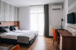 Postel nebo postele na pokoji v ubytování Lenti Thermal Panzió