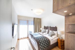 a bedroom with a bed and a large window at Genuss-Pension Herti in Übelbach +46 photos