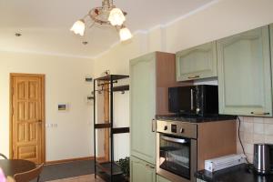 a kitchen with green cabinets and a microwave at Peipsi Lake House in Kallaste