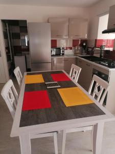 a kitchen with a table with colorful squares on it at La basse-cour in Vic-sur-Cère
