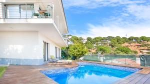 a house with a swimming pool and a balcony at 2Sant - Lloret de Mar in Lloret de Mar