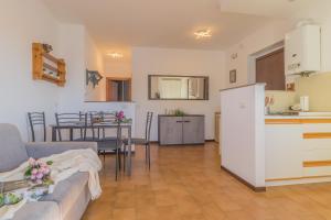 kuchnia i salon z kanapą i stołem w obiekcie Angolo con Vista w mieście Varenna