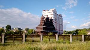 a building behind a fence in front of a building at Біля Озера in Ivano-Frankivsʼk