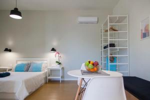 a bedroom with a bed and a table with fruit on it at Ligia Waterfront Apartments in Lygia