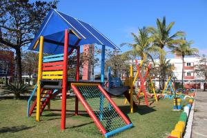 a playground with colorful playground equipment in a park at Satélite - Itanhaém in Itanhaém