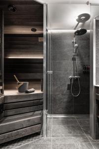 a bathroom with a shower with a glass door at Lapland Hotels Arena in Tampere +131 photos