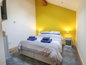 a bedroom with a large bed with blue towels on it at Pipistrelle in Stoke on Trent