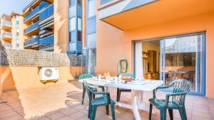 a patio with a table and chairs on a balcony at SantaCris 6 - Lloret de Mar in Lloret de Mar