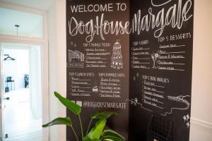 a chalkboard wall with a menu for a restaurant at Doghouse Margate in Kent