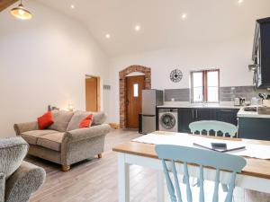 a kitchen and living room with a table and chairs at Robin's Rest in Stoke on Trent