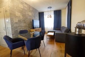 a living room with a couch and a table and chairs at MytoApartments in Mýto pod Ďumbierom