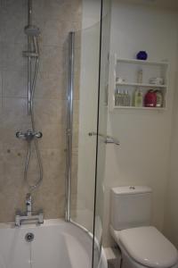 a bathroom with a shower and a tub and a toilet at Rectory Cottage in Abergavenny +17 photos