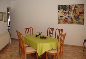 a dining room with a table with a green table cloth at Casa in Calpe Carrio Park in Calpe