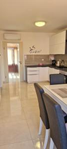 a kitchen with a table and chairs in a room at Apartman TESSA in Vela Luka