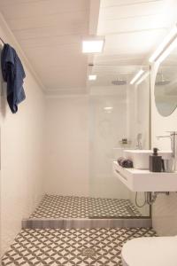 a white bathroom with a sink and a mirror at Ligia Waterfront Apartments in Lygia