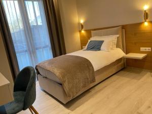 a bedroom with a bed and a large window at Albergo Aida in Luxembourg