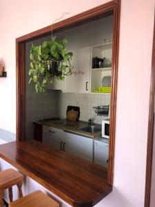 a kitchen with a table and a sink and a mirror at Atico Las Palomas in Santa Cruz de la Palma +33 photos