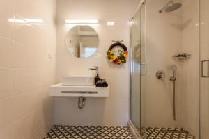 a white bathroom with a sink and a shower at Ligia Waterfront Apartments in Lygia +83 photos