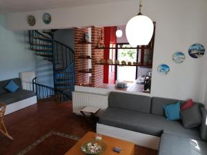 a living room with a couch and a staircase at Ananias House in Karianí