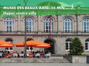 a building with tables and orange umbrellas in front of it at LE NID 2 QUIMPER BY Nid'Ouest in Quimper