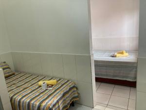 A bed or beds in a room at Residencial Gosto da Terra