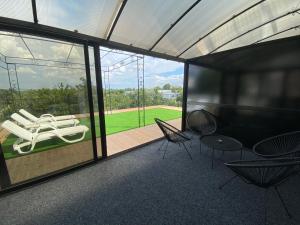 a room with chairs and a view of a baseball field at КОМПЛЕКС ОКЕЙ in Shumen