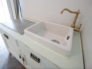 a white sink in a bathroom with a counter at Florita - Dawlish in Dawlish