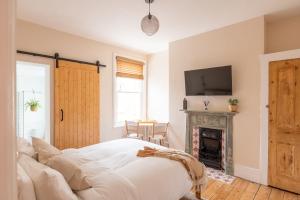 a bedroom with a bed and a fireplace at Doghouse Margate in Kent