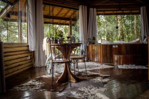 a room with a table and two chairs in it at Pousada Infinito in Visconde De Maua