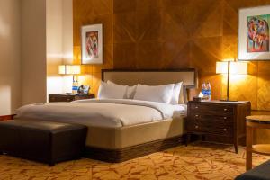 A bed or beds in a room at Lagos Continental Hotel