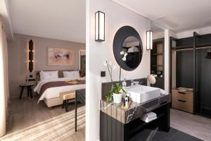 a bathroom with a bed and a sink and a mirror at S Hotel Boutique Thessaloniki in Thessaloniki