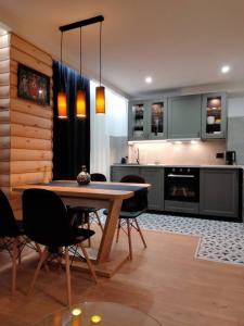 a kitchen and dining room with a table and chairs at Anielki Apartament in Zakopane
