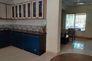 a kitchen with a blue counter and a window at Tangerine Stay - Friends & Family 4BHK Villa, Goa in Dabolim