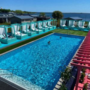 a swimming pool with two people in the water at Slite Strand resort in Slite