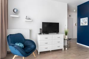Televízia a/alebo spoločenská miestnosť v ubytovaní Symphony Modern Tower Apartamenty