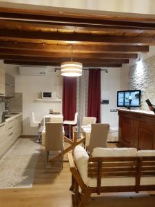 a living room with a table and chairs at Casa Virginia Antica Iglesias di Silvana in Iglesias