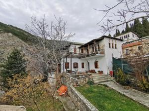 a white house on the side of a hill at Archontiko Elena in Volos
