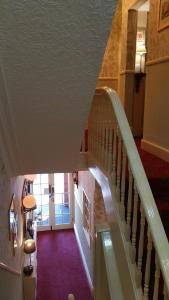 a staircase in a house with a red carpet at Westholme Hotel in Blackpool