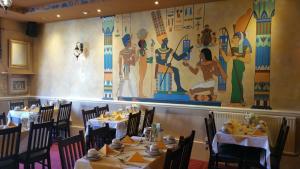 a dining room with tables and a painting on the wall at Westholme Hotel in Blackpool