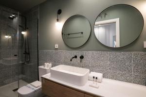 a bathroom with a sink and a mirror at Stylish 2 Bedroom Apartment in the Heart of Madrid in Madrid