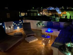 a view of a balcony at night with a blue lamp at Blue Meadow in Livadi Astypalaias