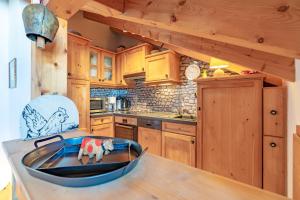 a kitchen with wooden cabinets and a wooden bowl on a table at Mein Lieblingsort in Burgberg
