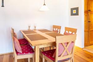 a wooden table and chairs in a room at Mein Lieblingsort in Burgberg +1 photo
