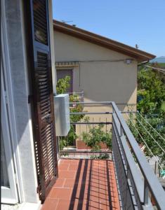a balcony of a house with a door open at Appartamento 5 in Ameglia