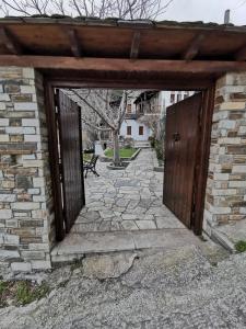 an entrance to a brick building with a wooden door at Archontiko Elena in Volos