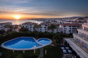 arial view of a villa with a swimming pool at sunset at Melia Sitges in Sitges
