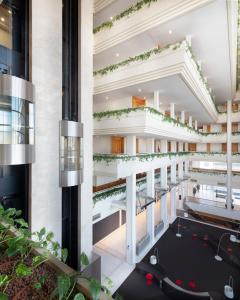 a view of the lobby of a building with escalators at Melia Sitges in Sitges