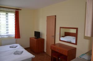 a hotel room with two beds and a mirror at Apartmány Na vršku in Dolní Moravice
